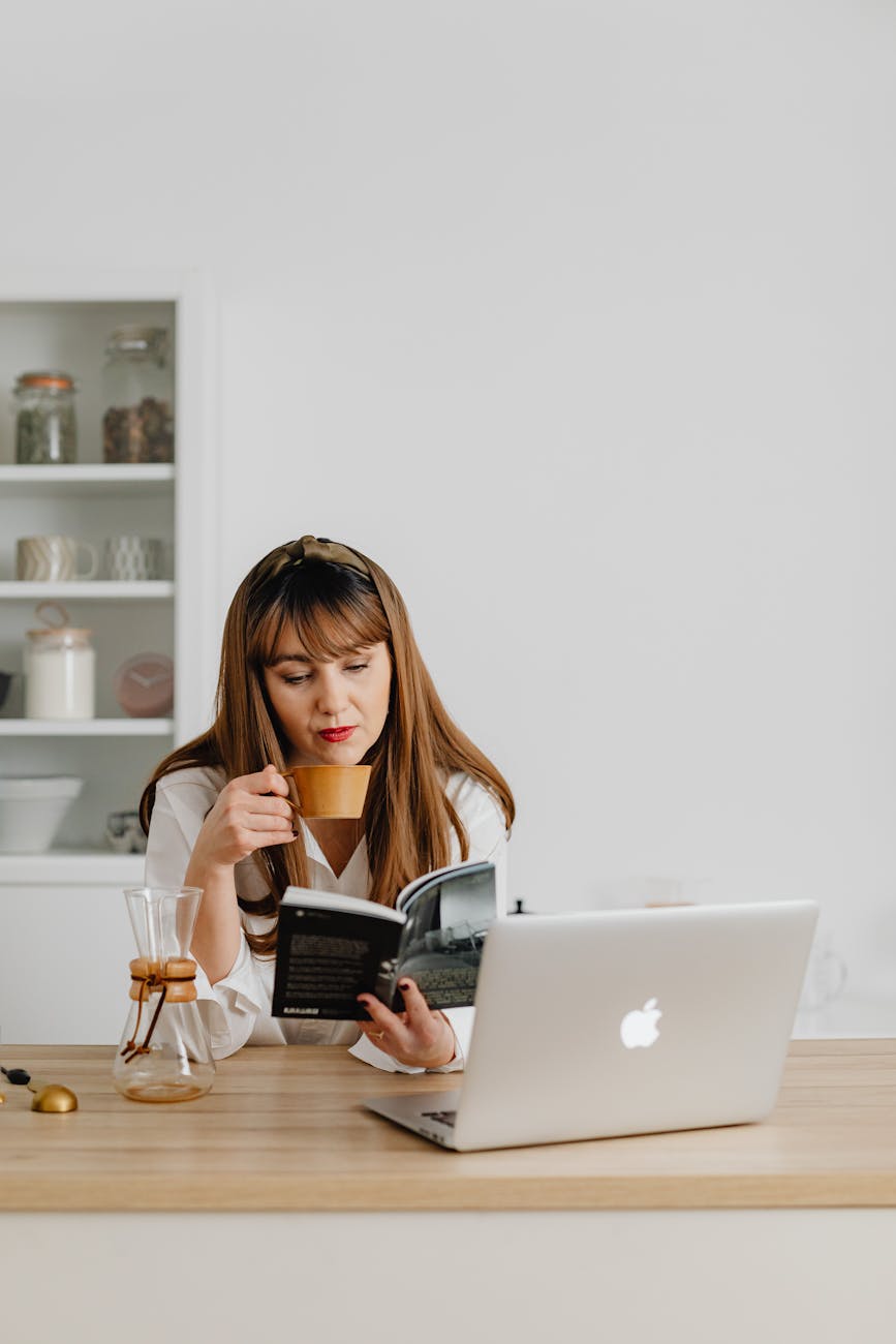 a woman reading a book while having coffee