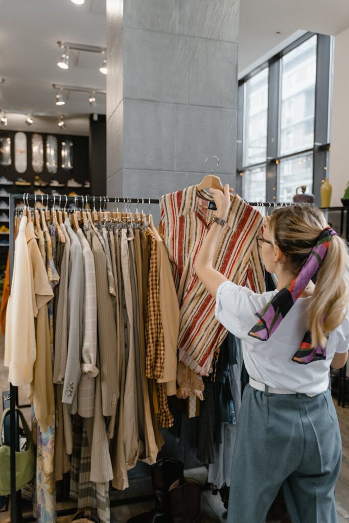 woman in white sleeve shirt standing near clothes rack