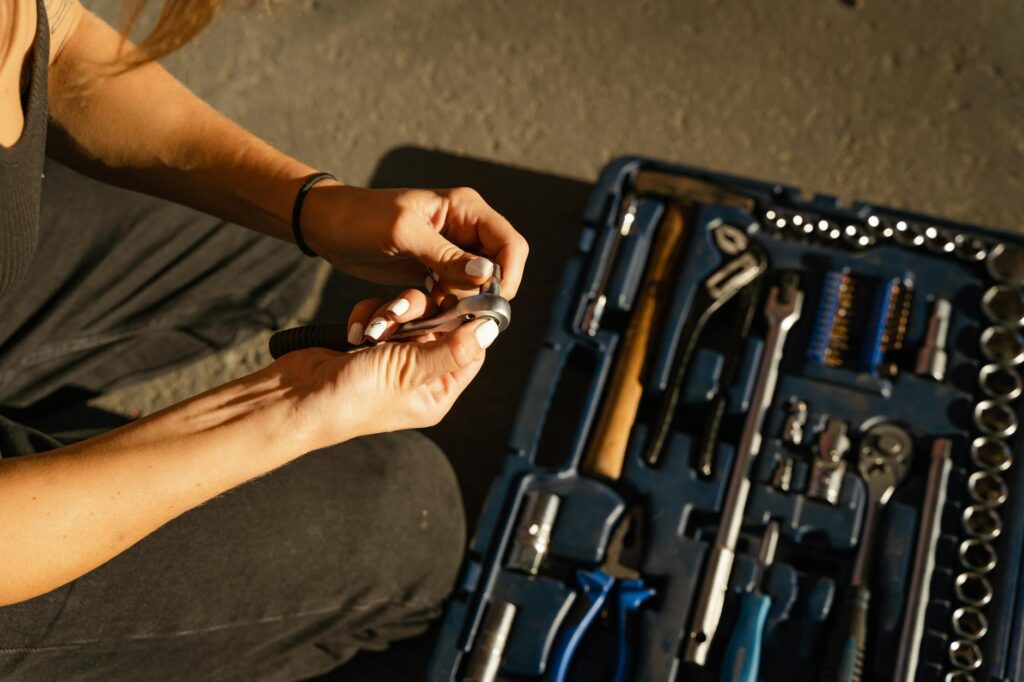a person holding steel tool and a bolt
